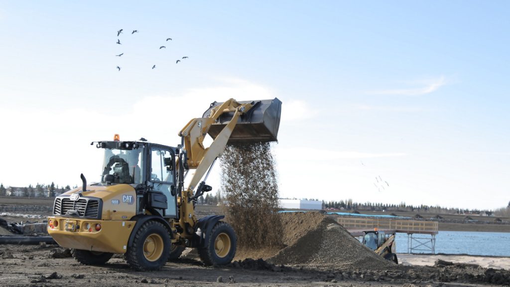 The Cat 908 compact wheel loader in a high lift configuration 