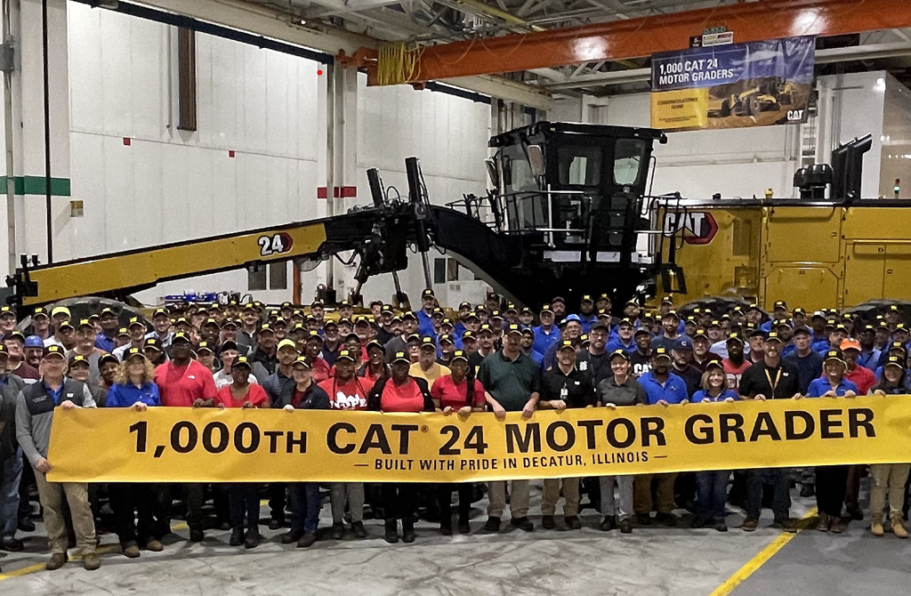 Caterpillar executives and motor grader production team members gathered in front of the 1,000th Cat 24 Motor Grader.