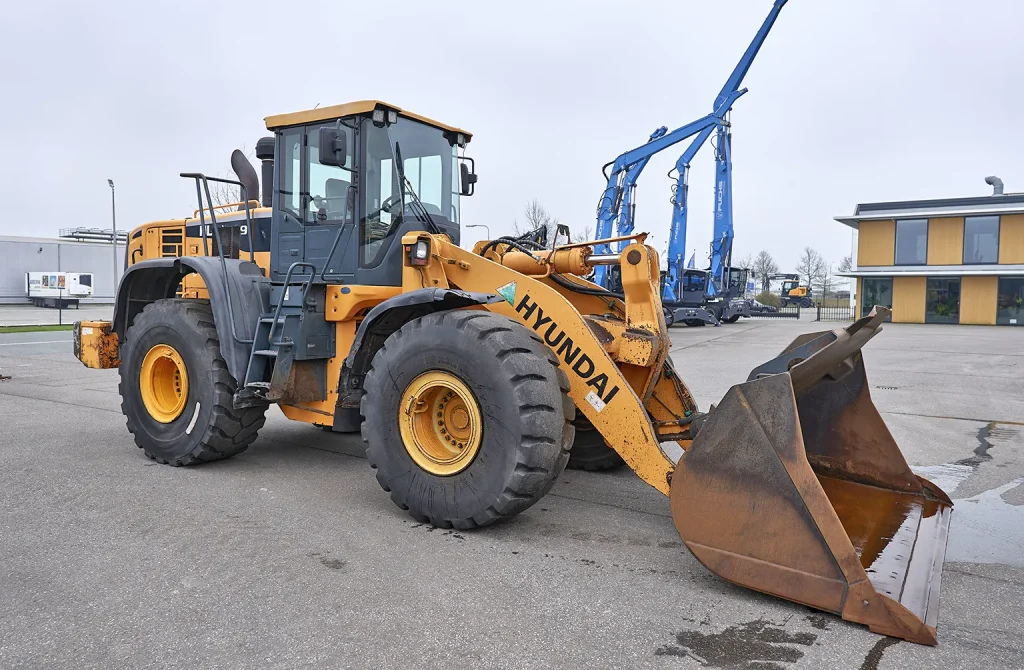 "Close-up of a Hyundai HL770-9 loader at a construction site, highlighting the need for detailed inspection and verification before buying used equipment abroad.